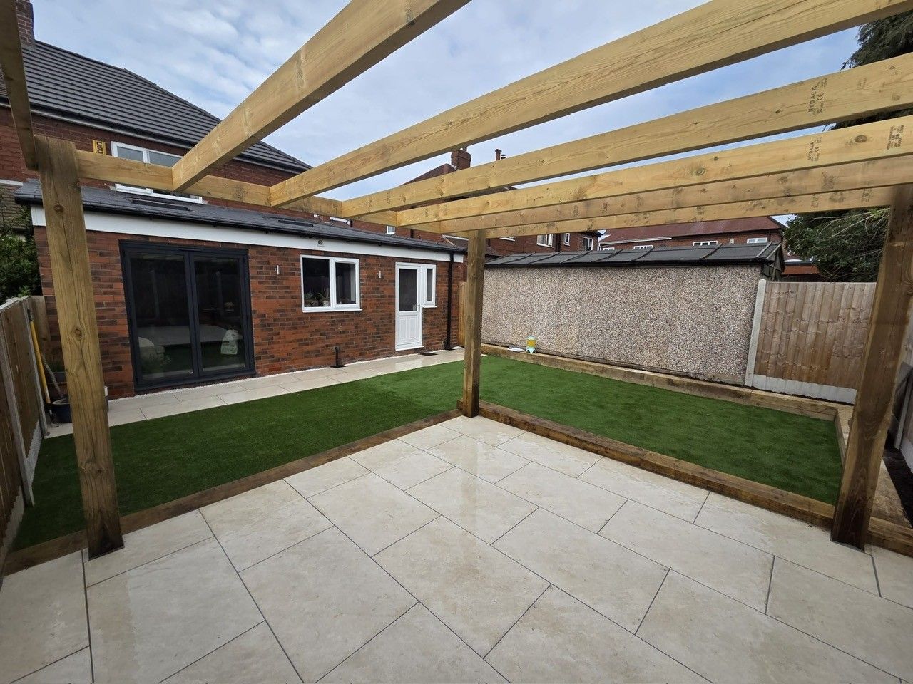 Extension with pergola and porcelain paving